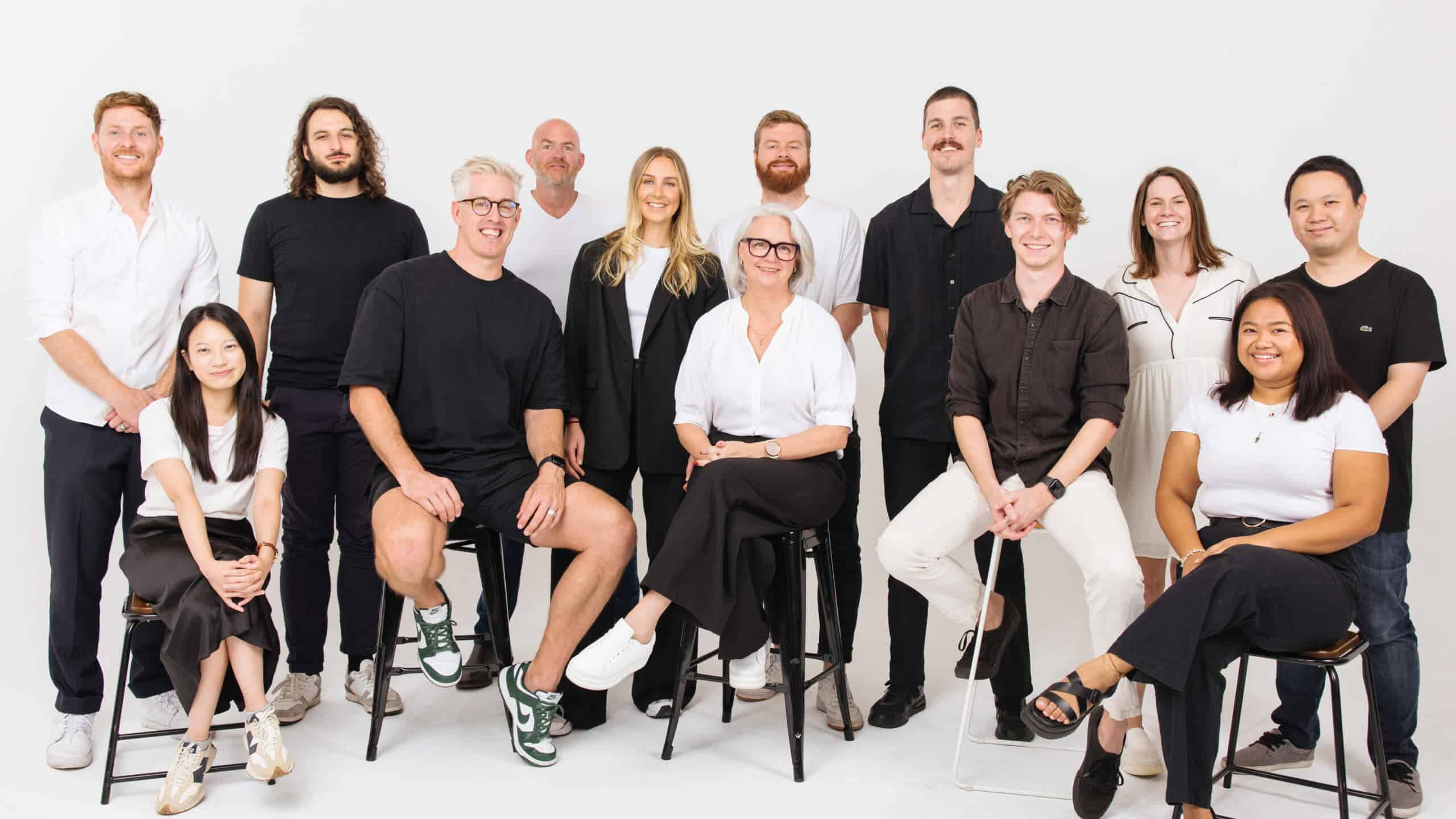 A group shot of the Unify team with 13 people in it. They are all acting silly.