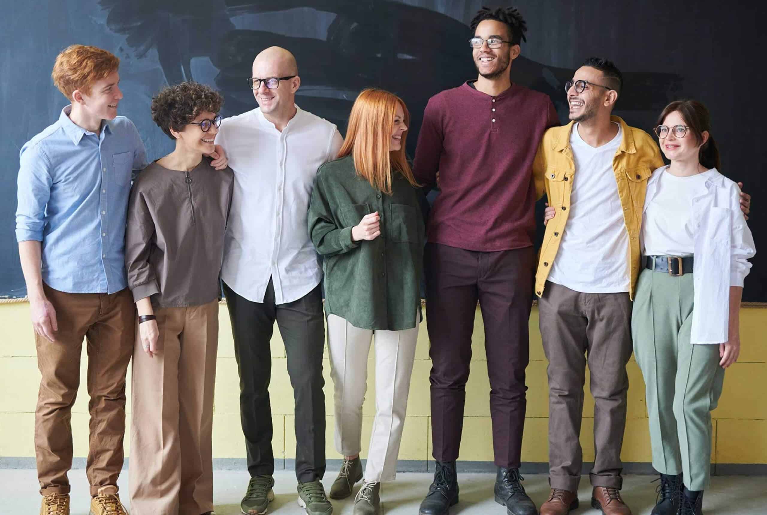A photo of a group of people, standing in a line.